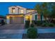 Charming two-story home with a well-manicured lawn and a two-car garage at dusk at 4337 S Helix --, Mesa, AZ 85212