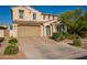 Charming two-story home with a two-car garage, desert landscaping, and a welcoming blue front door at 4337 S Helix --, Mesa, AZ 85212