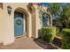 Charming front entrance with a blue door, a welcoming wreath, and verdant landscaping at 4337 S Helix --, Mesa, AZ 85212