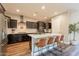 Modern kitchen with stainless appliances, wooden cabinets, island with seating, and bright lighting at 4337 S Helix --, Mesa, AZ 85212