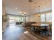 Spacious open-concept living area features a dining table and kitchen with island and backyard pool at 4337 S Helix --, Mesa, AZ 85212