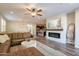 Open-concept living space with a comfortable sectional, fireplace, and seamless flow into the dining area at 4337 S Helix --, Mesa, AZ 85212
