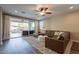 Comfortable living room showcasing a brown leather sectional, plush rug, and backyard access with a pool at 4337 S Helix --, Mesa, AZ 85212