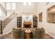 Elegant living room featuring hardwood floors, a piano, and two-story windows at 4337 S Helix --, Mesa, AZ 85212