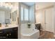 Bright bathroom featuring dual sinks, a soaking tub, and elegant fixtures at 4337 S Helix --, Mesa, AZ 85212