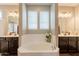 Luxurious main bathroom featuring dual sinks, a soaking tub, and elegant fixtures at 4337 S Helix --, Mesa, AZ 85212