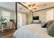 Comfortable main bedroom featuring a dedicated desk area and a mounted television at 4337 S Helix --, Mesa, AZ 85212