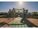 Community playground with modern equipment, slide, and climbing structure at 4337 S Helix --, Mesa, AZ 85212