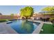 Beautiful pool featuring a travertine deck, lush turf, mature landscaping, and outdoor seating area with umbrella at 4337 S Helix --, Mesa, AZ 85212