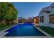 An inviting backyard pool with lounge area, complete with custom lighting and mature landscaping at 4337 S Helix --, Mesa, AZ 85212