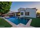 An inviting backyard pool with lounge area, complete with custom lighting and mature landscaping at 4337 S Helix --, Mesa, AZ 85212