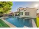 Gorgeous pool with a travertine deck, lush turf, and covered patio with seating, perfect for outdoor entertaining at 4337 S Helix --, Mesa, AZ 85212