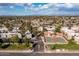 Expansive aerial view of community with mature trees, multiple residential buildings and amenities under a partly cloudy sky at 4554 E Paradise Village Pkwy # 267, Phoenix, AZ 85032