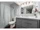 Updated bathroom with gray vanity, modern fixtures, and shower-tub combination at 4554 E Paradise Village Pkwy # 267, Phoenix, AZ 85032