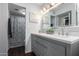 This bathroom offers a spacious vanity with dual sinks, tiled floors, and ample storage at 4554 E Paradise Village Pkwy # 267, Phoenix, AZ 85032