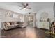Cozy living room features hardwood floors, ceiling fan, and sliding glass doors to the patio at 4554 E Paradise Village Pkwy # 267, Phoenix, AZ 85032