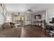 Cozy living room features hardwood floors, ceiling fan, and sliding glass doors to the patio at 4554 E Paradise Village Pkwy # 267, Phoenix, AZ 85032