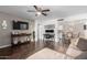 Open-concept living room with dark wood floors, neutral walls and a TV at 4554 E Paradise Village Pkwy # 267, Phoenix, AZ 85032
