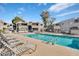 Community pool with lounge chairs and tables, with multi-story residential buildings in the background at 4554 E Paradise Village Pkwy # 267, Phoenix, AZ 85032