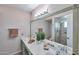 Bathroom featuring double sinks, large mirror, and glass enclosed shower at 4815 E Everett Dr, Scottsdale, AZ 85254