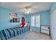 Blue bedroom with striped bed and window at 4815 E Everett Dr, Scottsdale, AZ 85254