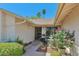 Inviting entryway featuring a well-manicured garden with beautiful flowers and a secure screened front door at 4815 E Everett Dr, Scottsdale, AZ 85254
