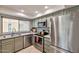 Well-equipped kitchen with stainless steel appliances, neutral cabinetry, and an undermount sink under a bright window at 4815 E Everett Dr, Scottsdale, AZ 85254