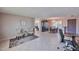 Open-concept living area with tile flooring, neutral walls, and views into the dining room and kitchen at 4815 E Everett Dr, Scottsdale, AZ 85254