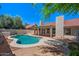 Tranquil backyard featuring a pool, covered patio, and lush landscaping at 509 W Boxelder Pl, Chandler, AZ 85225