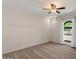 Large room with ceiling fan, carpet, an arched window with views of the street and front yard at 509 W Boxelder Pl, Chandler, AZ 85225
