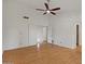 Large room with ceiling fan, wood-look flooring, and doors to adjoining rooms and closets at 509 W Boxelder Pl, Chandler, AZ 85225