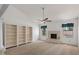 Cozy bedroom featuring plush carpeting, a fireplace, built-in bookshelves, and natural light at 509 W Boxelder Pl, Chandler, AZ 85225