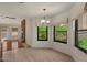 Bright dining area features tile flooring, large windows with backyard views and contemporary chandelier at 509 W Boxelder Pl, Chandler, AZ 85225