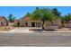 View of a well-maintained home featuring a red tile roof, arched windows, and mature trees at 509 W Boxelder Pl, Chandler, AZ 85225