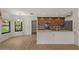 Bright kitchen with stainless steel appliances, dark cabinets, and a breakfast bar at 509 W Boxelder Pl, Chandler, AZ 85225
