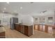 Open kitchen with stainless steel appliances and an adjacent living space with a pool view at 509 W Boxelder Pl, Chandler, AZ 85225
