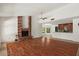 Spacious living room with hardwood floors, a brick fireplace, and ample natural light at 509 W Boxelder Pl, Chandler, AZ 85225