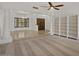 Bright living room featuring a ceiling fan, tile floors, and built-in white bookshelves at 509 W Boxelder Pl, Chandler, AZ 85225