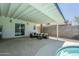 Spacious covered patio with comfortable seating near the pool and lush landscaping at 520 N 23Rd St, Mesa, AZ 85213