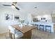 The dining room features a modern table with seating for six, with a kitchen bar in the background at 520 N 23Rd St, Mesa, AZ 85213