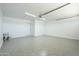 Spacious garage with epoxy floors, white walls, and door to outside at 520 N 23Rd St, Mesa, AZ 85213