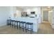 The kitchen includes a long breakfast bar with seating for four, and stainless-steel appliances at 520 N 23Rd St, Mesa, AZ 85213
