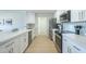 Modern kitchen with stainless steel appliances, white cabinets, quartz countertops and wood floors at 520 N 23Rd St, Mesa, AZ 85213