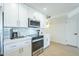 Bright kitchen with stainless steel oven and microwave, quartz countertops, subway tile backsplash, and white cabinets at 520 N 23Rd St, Mesa, AZ 85213