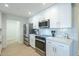 The bright kitchen features white cabinets, stainless steel appliances and quartz countertops at 520 N 23Rd St, Mesa, AZ 85213