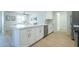 Beautiful modern kitchen bar with stainless steel dishwasher and sink, quartz countertops, and hardwood flooring at 520 N 23Rd St, Mesa, AZ 85213
