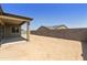 Backyard showcasing a covered patio and a partial block fence that offers privacy at 5533 N 193Rd Ave, Litchfield Park, AZ 85340