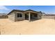 A home's exterior backyard showcases a covered patio, and a blank canvas for landscaping at 5533 N 193Rd Ave, Litchfield Park, AZ 85340