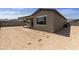 Exterior rear view of the property highlighting the covered patio and spacious backyard at 5533 N 193Rd Ave, Litchfield Park, AZ 85340
