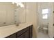 Bathroom showcases a spacious vanity with stylish cabinets, a large mirror, and access to the shower/tub at 5533 N 193Rd Ave, Litchfield Park, AZ 85340